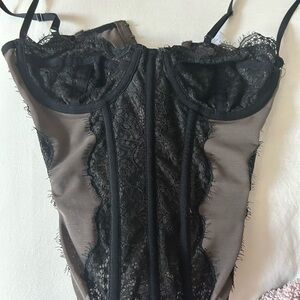 Out from under black lace corset